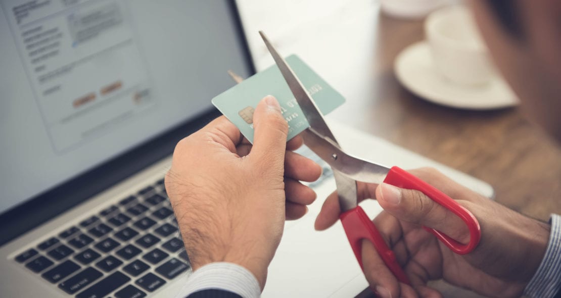 Man cutting up credit card