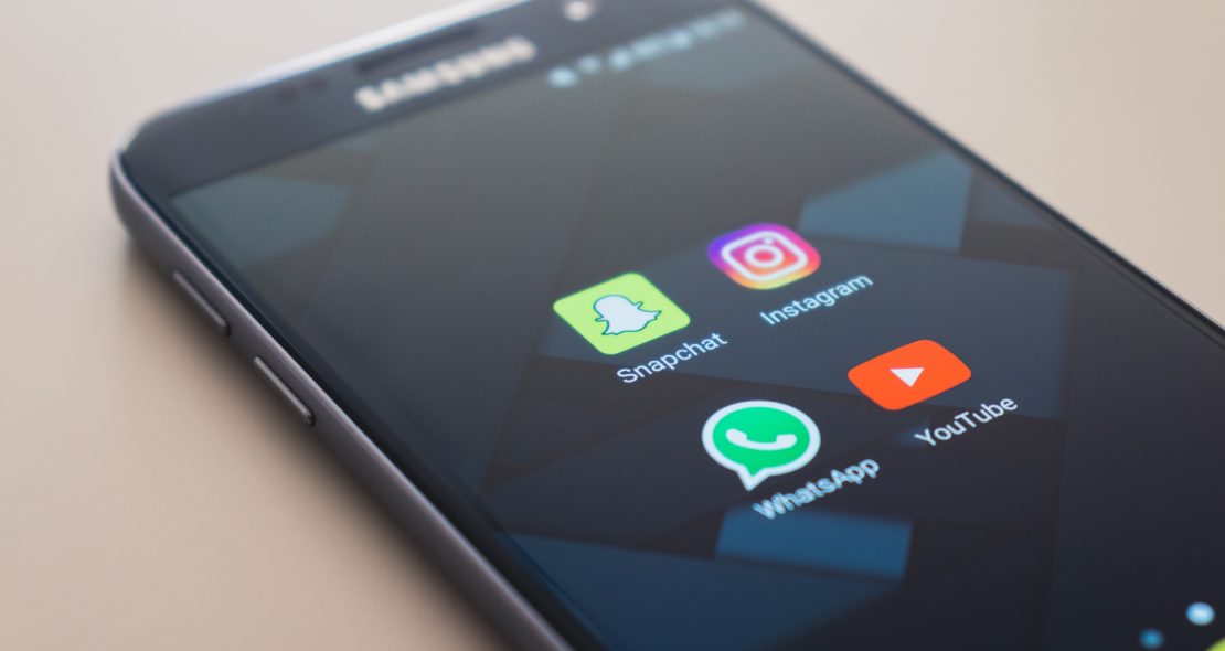 Close up of phone displaying Instagram, Whatsapp, Snapchat and Whatsapp apps